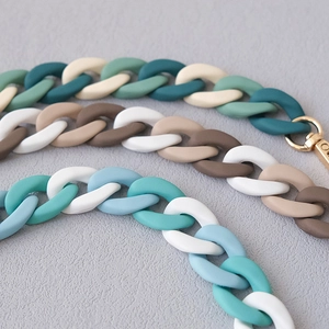 Detail of matte acrylic fishbone phone chains in multicolor resin with gold lobster clasps