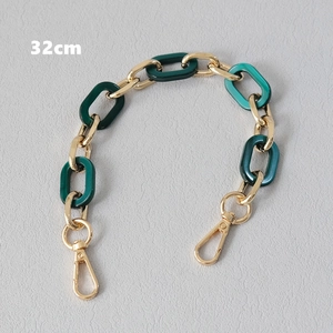 Detail view of a 32cm bag handle with green resin links and golden lobster clasps