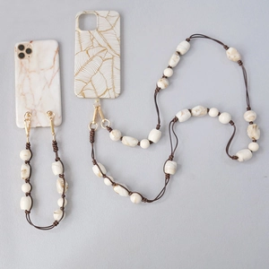 Detail of acrylic bead chain with marble texture and gold leaf phone case designs