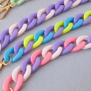 Macro shot of colorful acrylic chain links with gold lobster clasps and rings