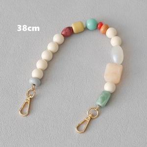 Detail showing 38cm multi-colored resin bead chain with gold metal lobster clasps