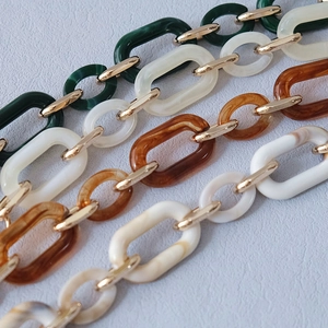 Acrylic resin chain straps with gold links in marble, amber, cream and green
