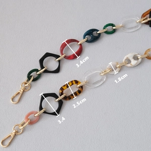 Detail showing acrylic resin bag chain links with gold rings and dimension measurements