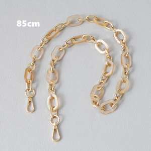 Detailed 85cm bag strap featuring marbled resin links and golden metal hardware