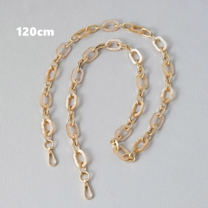 Detailed view of 120cm gold metal and cream acrylic link chain with lobster clasps
