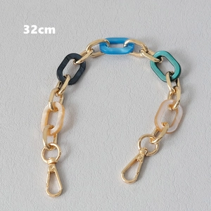 Detail view of 32cm acrylic and gold metal chain strap with marble texture links