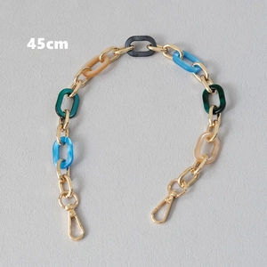 Detail of 45cm acrylic and gold metal chain strap with colorful resin links and lobster clasps