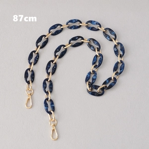 Detail view of 87cm dark blue marble resin bag strap with gold metal lobster clasps