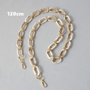 Detail of 120cm marble resin chunky bag strap with gold metal links and lobster clasp