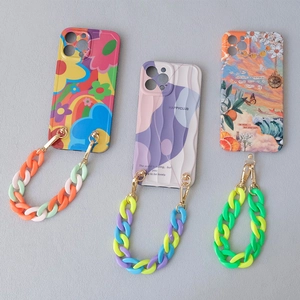 Detailed view of colorful acrylic fishbone phone chains and patterned resin phone cases