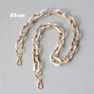 Close-up of 85cm resin bag strap with marble texture links and gold lobster clasps