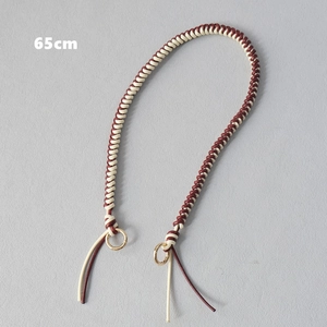 Detailed view of 65cm woven wax rope strap with gold metal rings for handbags