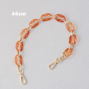 Detail view of a 46cm amber resin and gold metal chain strap with lobster clasps