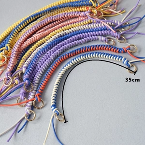 Detail of 35cm colorful braided wax rope bag chain with glossy gold circular metal buckles