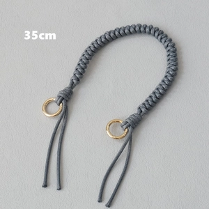 Detailed view of 35cm grey braided wax rope bag handle with gold circular metal rings