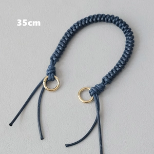 Detail of 35cm dark blue woven wax rope handbag strap with gold metal ring buckles