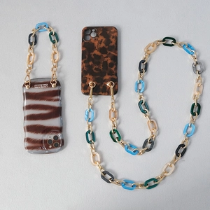 Detailed view of leopard and tortoiseshell cases with acrylic gold metal chain straps