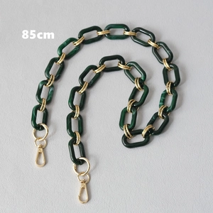 Detail view of 85cm dark green resin chain strap with gold metal links and lobster clasp