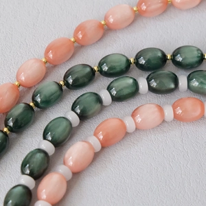 Detailed macro view of opal texture beads with gold metal spacers and silk luster finish
