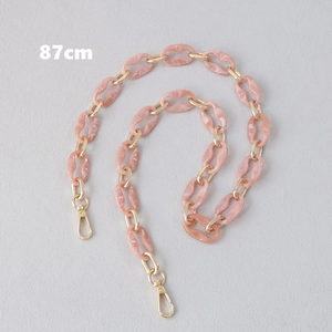 Detail view of 87cm marble pink acrylic chain strap with gold metal rings and lobster clasps