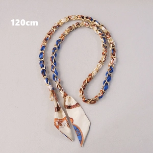 Close-up of 120cm gold metal chain interwoven with vintage blue and orange silk ribbon