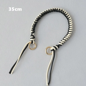 Detailed 35cm black and white woven handle strap with gold circular metal rings