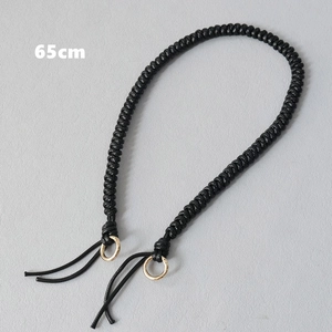 Detailed view of 65cm black braided rope handle with light gold metal rings for handbags
