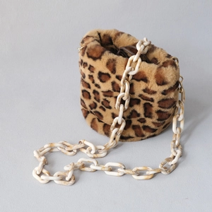 Close-up of leopard print faux fur bucket bag featuring a thick milky white acrylic chain