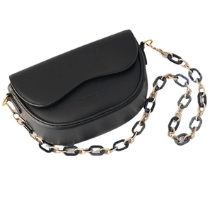 Black matte leather saddle bag featuring chunky acrylic and gold metal chain strap