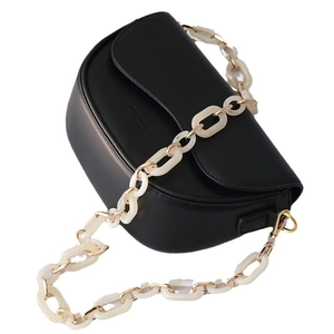 Black leather crossbody bag with chunky cream acrylic chain strap and gold hardware