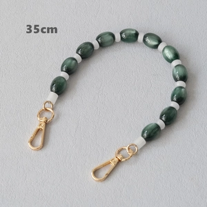 Detail of 35cm green marble resin chain with gold lobster clasps and white bead spacers