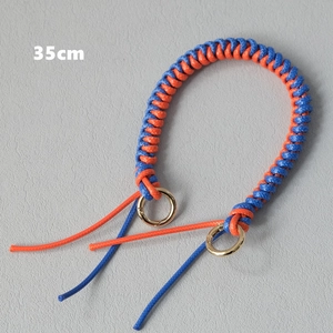 Close-up of a 35cm orange and blue braided rope handbag strap with gold metal rings