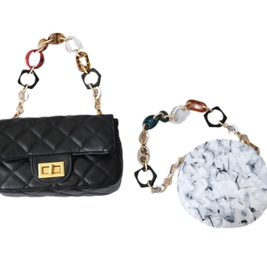 Retro acrylic chunky chain straps on black quilted bag and marble round resin purse