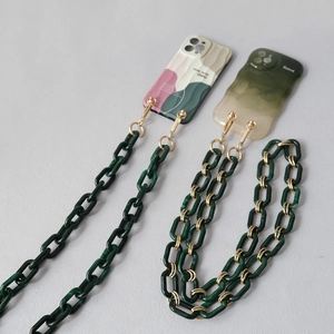 Detail of green acrylic resin link chain with golden metal clasp for iPhone case
