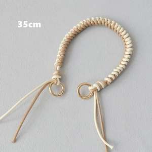 Detailed 35cm braided leather bag strap with gold metal rings in beige and cream