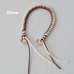Detailed 35cm burgundy and beige woven bag strap with golden metal clasps and textured finish