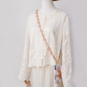 Crossbody pink acrylic chain and floral phone case shown on a lace shirt model