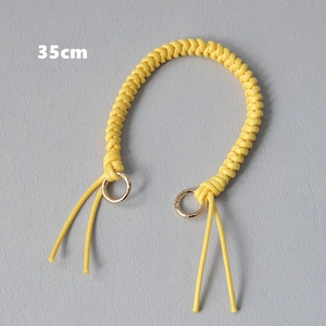 Close-up of 35cm yellow braided bag strap handle with golden metal snap rings