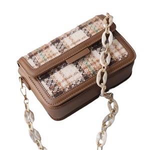 Retro plaid crossbody bag featuring a thick white marble resin and gold metal chain strap
