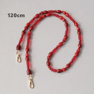 Detail view of 120cm red acrylic beaded strap with premium golden lobster clasps