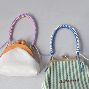 Detail of handmade woven handles and metal clasps on trendy canvas and leather mini bags
