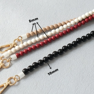 Lanières chics en perles acryliques beiges, blanches, rouges et noires avec fermoirs dorés