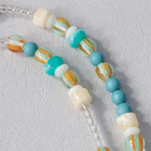 Close-up of colorful acrylic beads and handmade textures for phone or bag strap chains