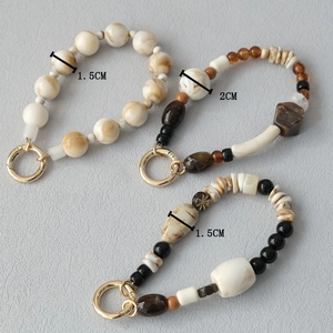 Detailed macro view of acrylic beaded mobile chains with 1.5cm and 2cm marbles