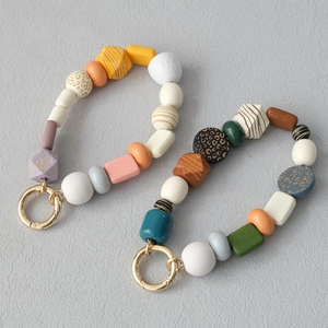 Detail of colorful acrylic beads and gold spring rings for handmade phone lanyards