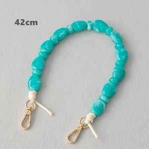 Detail of 42cm green marble resin bead strap with golden metal lobster clasps for bags