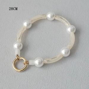 Detailed view of 28cm acrylic beads and faux pearls phone strap with gold spring ring