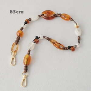 Detail of 63cm resin bead chain with amber oval beads and gold metal clasps