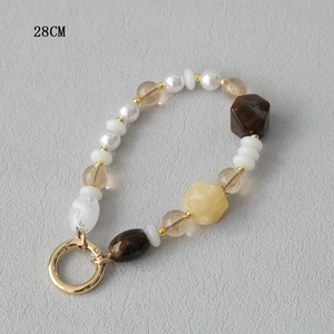 Detail shot of 28cm acrylic bead phone strap with mixed amber and marble texture beads