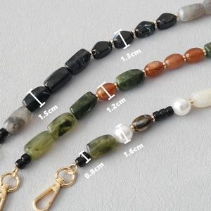 Golden acrylic beaded phone chain with marble resin beads and lobster clasp hardware